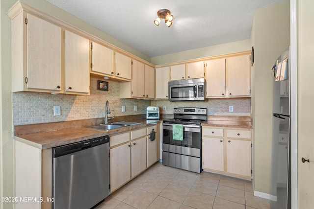 1655 The Greens Way Unit 2432, Jacksonville Beach, FL 32250 - kitchen with stainless steel appliances, a sink, light tile patterned floors, and decorative backsplash