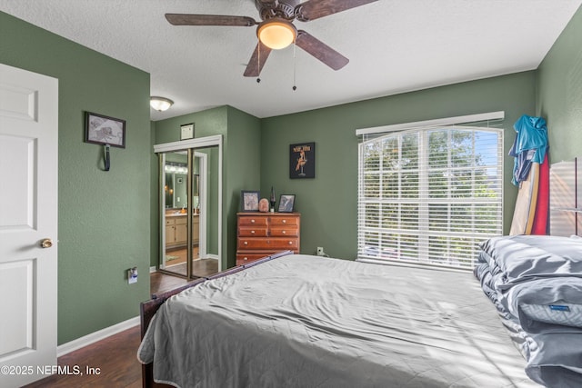 1655 The Greens Way Unit 2432, Jacksonville Beach, FL 32250 - bedroom with wood finished floors, baseboards, a ceiling fan, a textured wall, and a closet
