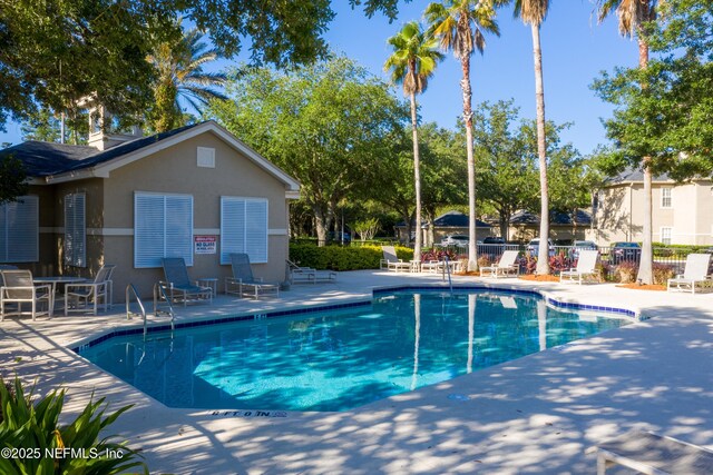1655 The Greens Way Unit 2432, Jacksonville Beach, FL 32250 - community pool with a patio and fence