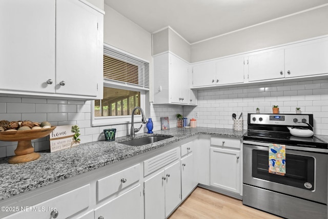 5164 Marlene Ave, Jacksonville, FL 32210 - kitchen featuring stainless steel electric stove, a sink, white cabinets, and light stone countertops