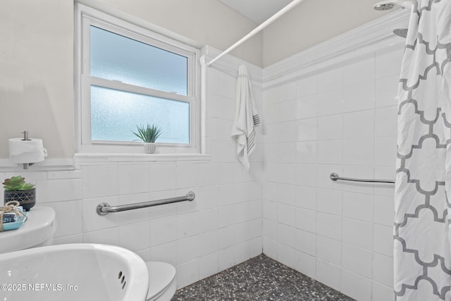 5164 Marlene Ave, Jacksonville, FL 32210 - bathroom featuring tiled shower and wainscoting