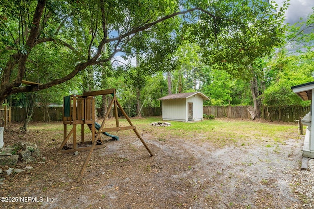 5164 Marlene Ave, Jacksonville, FL 32210 - fenced backyard featuring a playground, a shed, and an outbuilding