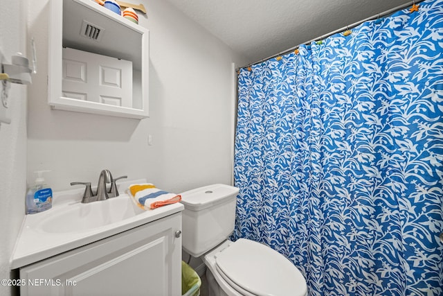 7175 A1A S Unit A108, Saint Augustine, FL 32080 - bathroom featuring toilet, vanity, a textured ceiling, and a shower with shower curtain