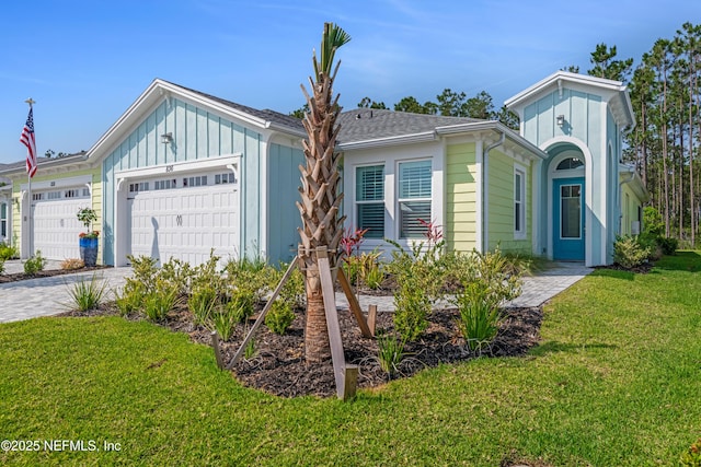 836 Margaritaville Ave, Daytona Beach, FL 32124 - view of front of home with a front lawn, a garage, driveway, and board and batten siding