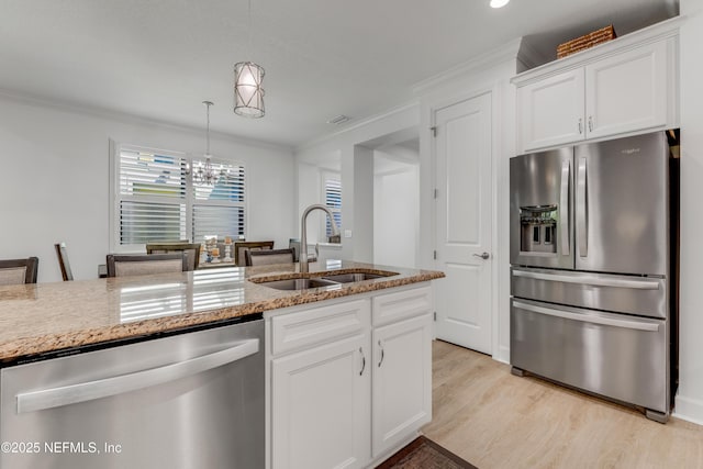 836 Margaritaville Ave, Daytona Beach, FL 32124 - kitchen with stainless steel appliances, a sink, ornamental molding, light stone counters, and light wood-type flooring