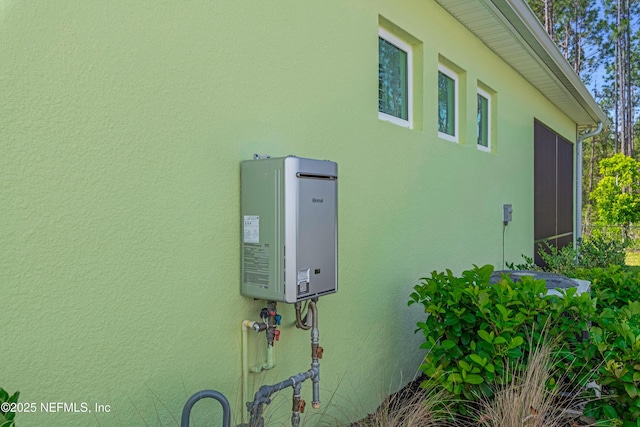836 Margaritaville Ave, Daytona Beach, FL 32124 - exterior view of water heater and stucco siding