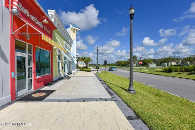 836 Margaritaville Ave, Daytona Beach, FL 32124 - view of asphalt road with street lights and traffic signs