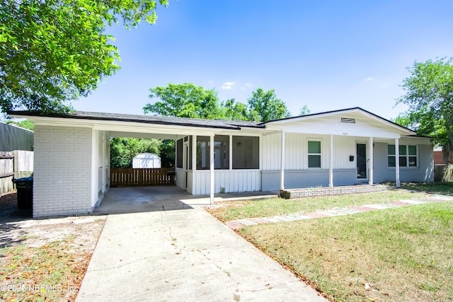 7315 Wonder Ln, Jacksonville, FL 32244 - view of front of house with brick siding, driveway, an attached carport, board and batten siding, and covered porch
