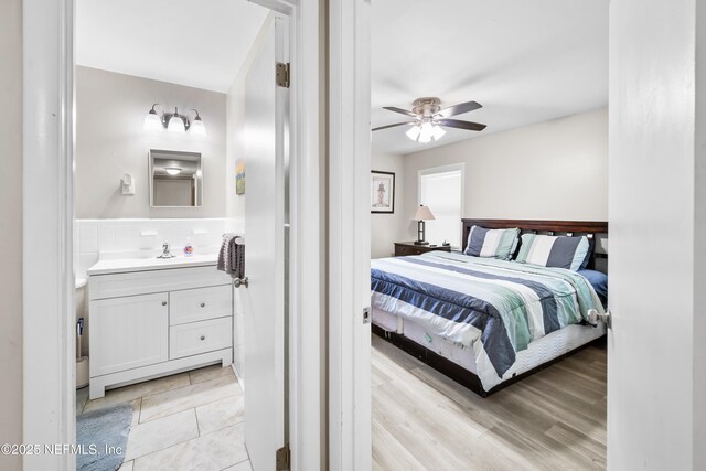 7315 Wonder Ln, Jacksonville, FL 32244 - bedroom featuring connected bathroom, a sink, and a ceiling fan