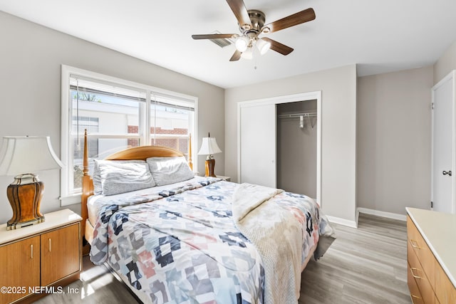 7315 Wonder Ln, Jacksonville, FL 32244 - bedroom featuring light wood-style floors, a closet, baseboards, and a ceiling fan