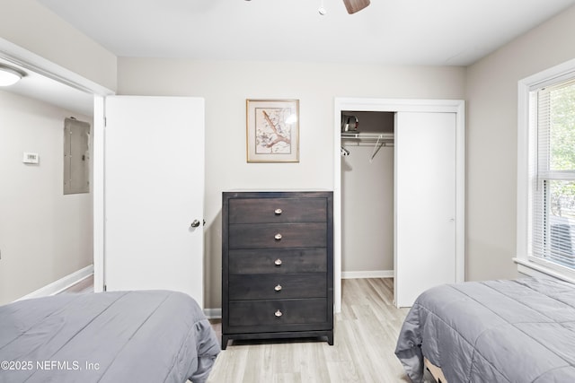 7315 Wonder Ln, Jacksonville, FL 32244 - bedroom with light wood-style floors, electric panel, a closet, baseboards, and a ceiling fan