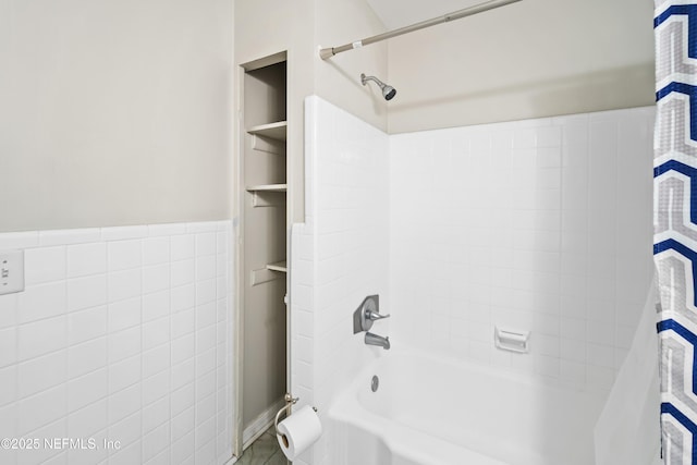 7315 Wonder Ln, Jacksonville, FL 32244 - bathroom featuring washtub / shower combination, tile walls, and wainscoting