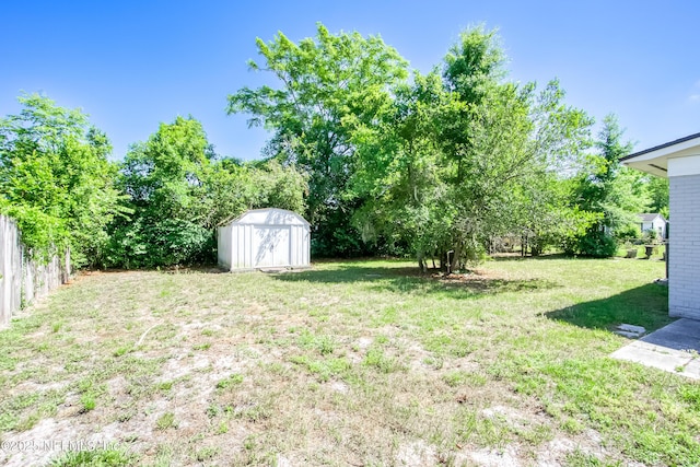 7315 Wonder Ln, Jacksonville, FL 32244 - view of grassy yard featuring a storage shed and an outdoor structure