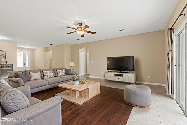 213 Haas Ave, Saint Augustine, FL 32095 - tiled living room with arched walkways, ceiling fan, and baseboards