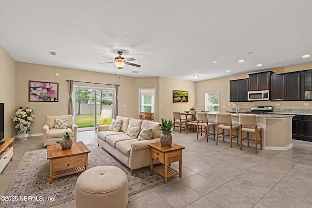 213 Haas Ave, Saint Augustine, FL 32095 - living area with light tile patterned flooring, a ceiling fan, recessed lighting, a textured ceiling, and baseboards