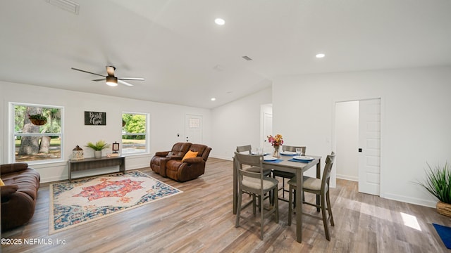 dining space featuring lofted ceiling, wood finished floors, baseboards, a ceiling fan, and recessed lighting
