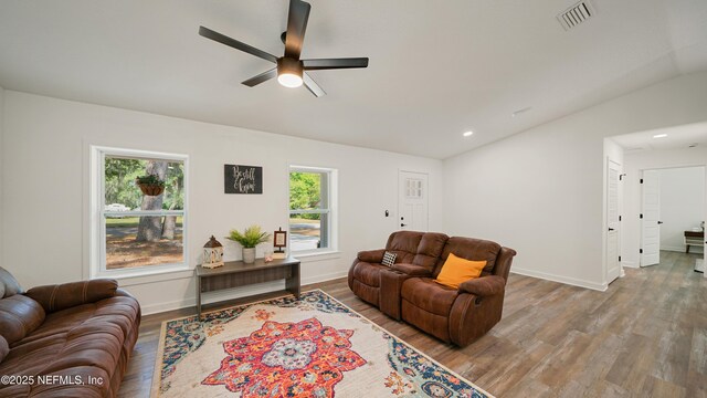 living room featuring lofted ceiling, wood finished floors, a ceiling fan, baseboards, and recessed lighting