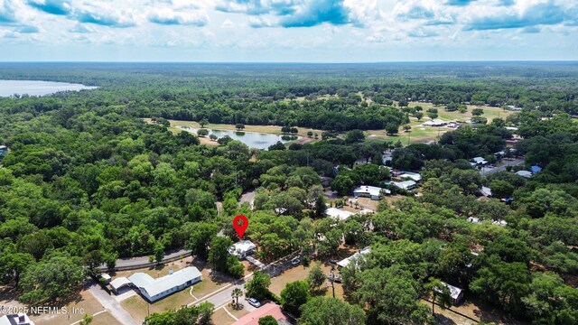 aerial view of a heavily wooded area and a nearby body of water