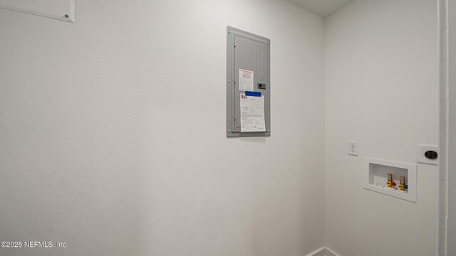 washroom with washer hookup, electric panel, and baseboards