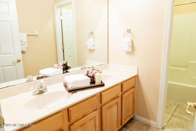 2543 Willow Creek Dr, Fleming Island, FL 32003 - full bath featuring tile patterned floors, double vanity, shower / washtub combination, and baseboards