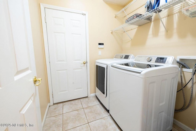 2543 Willow Creek Dr, Fleming Island, FL 32003 - laundry area with independent washer and dryer, baseboards, and light tile patterned flooring
