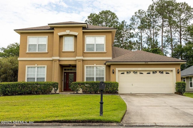2543 Willow Creek Dr, Fleming Island, FL 32003 - view of front of house with stucco siding, driveway, an attached garage, and a front yard