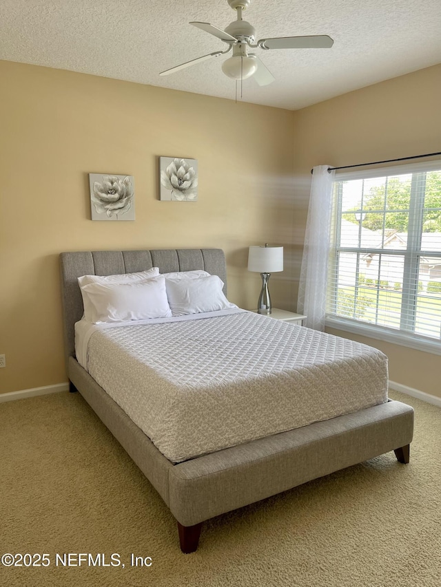 2543 Willow Creek Dr, Fleming Island, FL 32003 - bedroom with carpet, baseboards, a textured ceiling, and ceiling fan