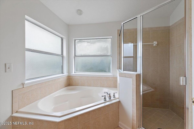 full bathroom featuring a garden tub and a stall shower