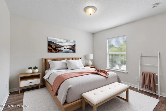 bedroom with wood finished floors and baseboards