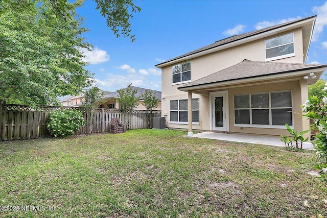 rear view of property with stucco siding, central AC unit, a patio area, and roof with shingles