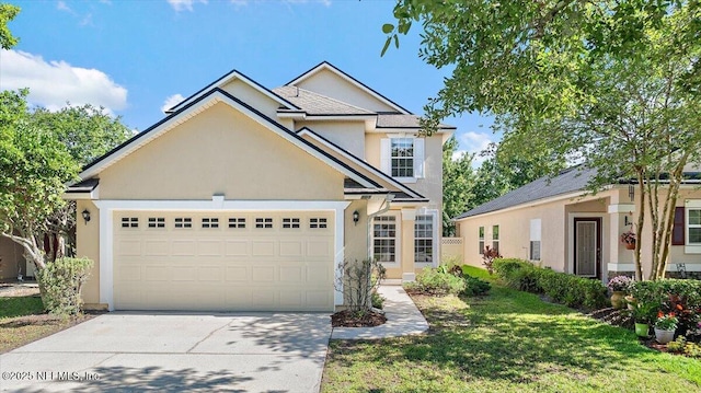 traditional home with stucco siding, driveway, a garage, and a front lawn