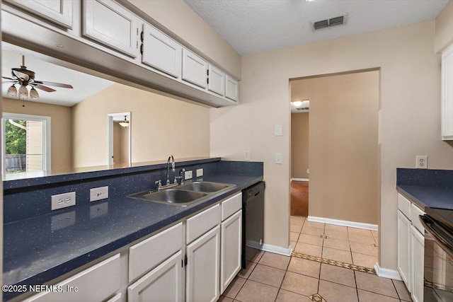 kitchen featuring a sink, black appliances, white cabinetry, dark countertops, and a ceiling fan