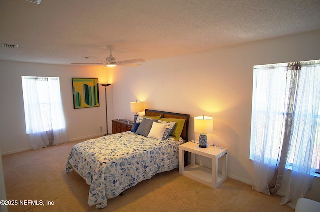 bedroom featuring light colored carpet, baseboards, and ceiling fan
