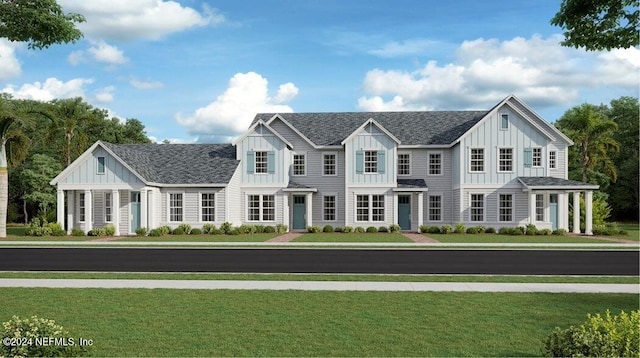 view of front facade with board and batten siding, a front lawn, and roof with shingles