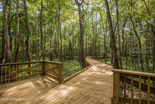 deck featuring a forest view