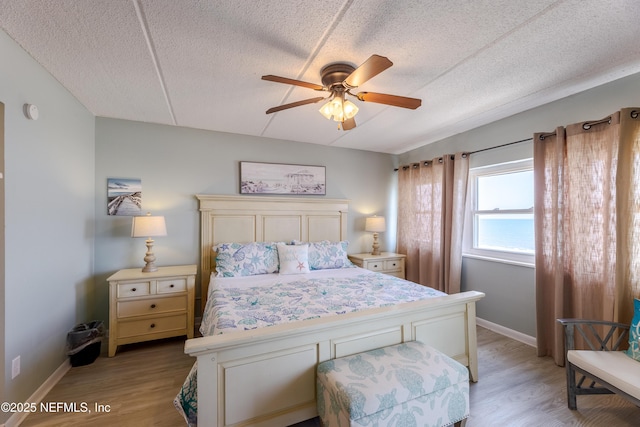 3350 S Fletcher Ave Unit D5, Fernandina Beach, FL 32034 - bedroom featuring light wood-style floors, a textured ceiling, baseboards, and a ceiling fan