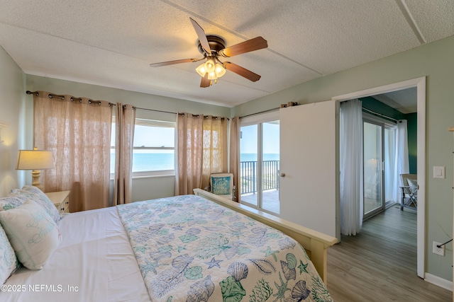3350 S Fletcher Ave Unit D5, Fernandina Beach, FL 32034 - bedroom featuring access to outside, wood finished floors, a textured ceiling, ceiling fan, and baseboards