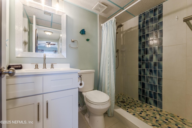 3350 S Fletcher Ave Unit D5, Fernandina Beach, FL 32034 - bathroom with toilet, tile patterned flooring, a tile shower, vanity, and ceiling fan