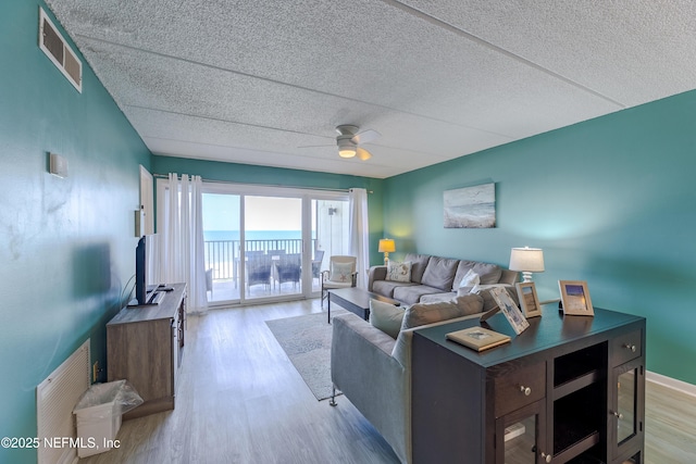3350 S Fletcher Ave Unit D5, Fernandina Beach, FL 32034 - living room with light wood-type flooring, a ceiling fan, and a textured ceiling