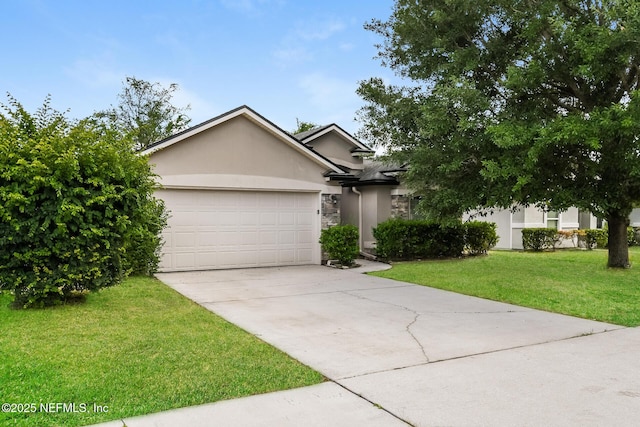 view of property hidden behind natural elements featuring stucco siding, an attached garage, concrete driveway, a front lawn, and stone siding
