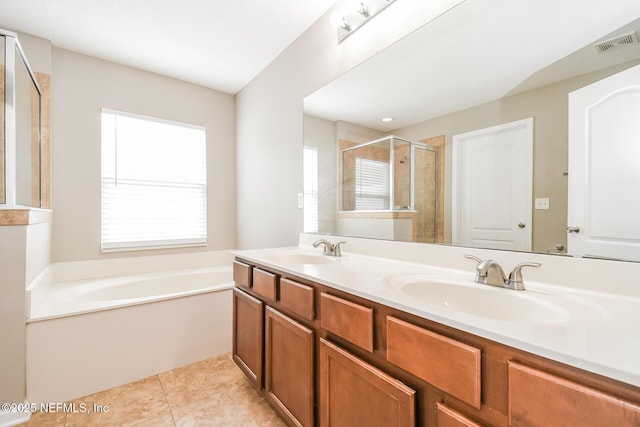 full bathroom with a shower stall, a garden tub, double vanity, and tile patterned flooring