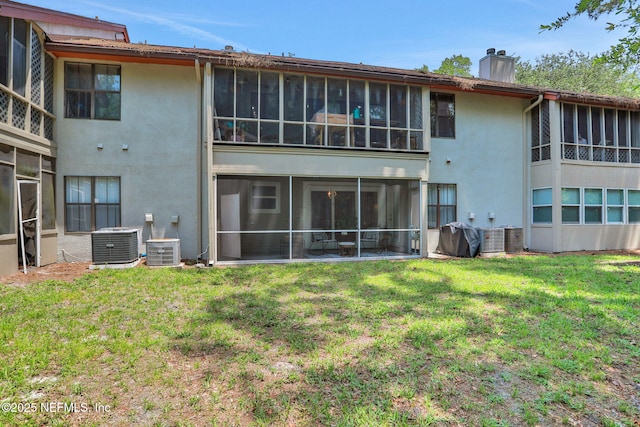 1303 Wood Hill Pl Unit 1303, Jacksonville, FL 32256 - back of property featuring a chimney, stucco siding, a sunroom, and central air condition unit