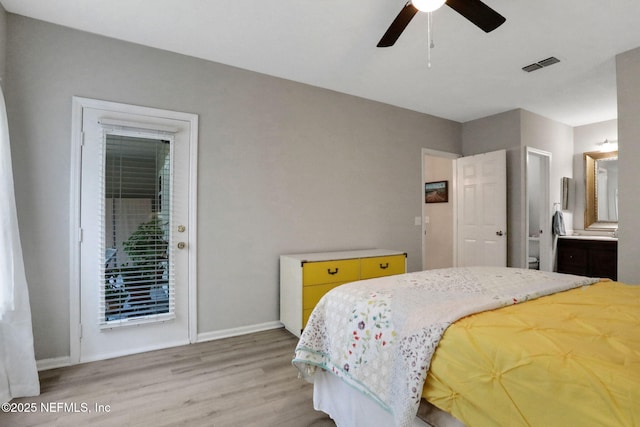 1303 Wood Hill Pl Unit 1303, Jacksonville, FL 32256 - bedroom featuring light wood-style flooring, baseboards, and ensuite bath