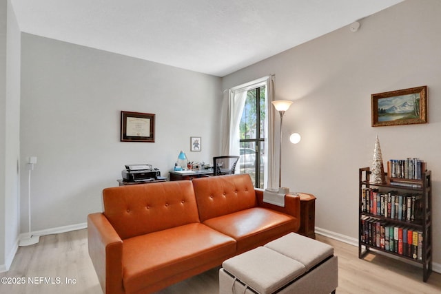 1303 Wood Hill Pl Unit 1303, Jacksonville, FL 32256 - living room with light wood-type flooring, baseboards, and an office area