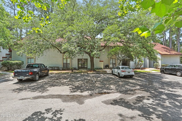 1303 Wood Hill Pl Unit 1303, Jacksonville, FL 32256 - view of front of property featuring uncovered parking and stucco siding