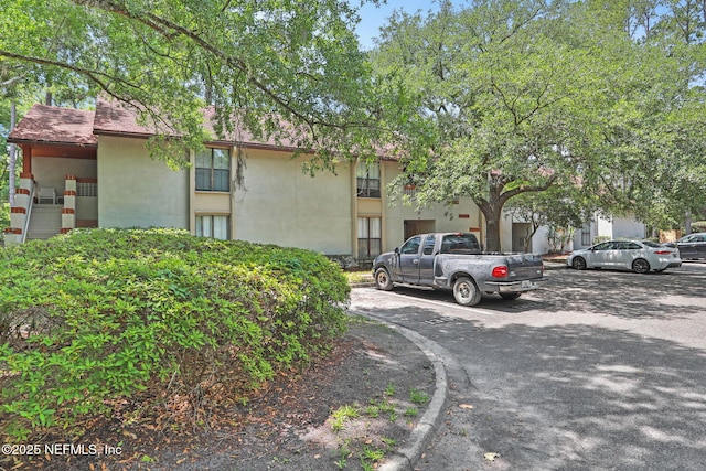 1303 Wood Hill Pl Unit 1303, Jacksonville, FL 32256 - view of building exterior with uncovered parking