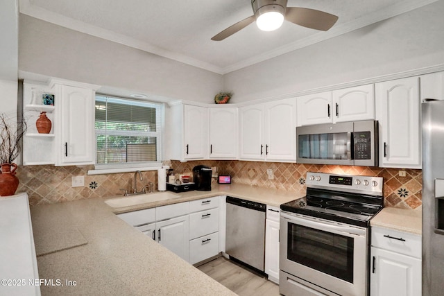 1303 Wood Hill Pl Unit 1303, Jacksonville, FL 32256 - kitchen featuring stainless steel appliances, a sink, white cabinets, and ornamental molding