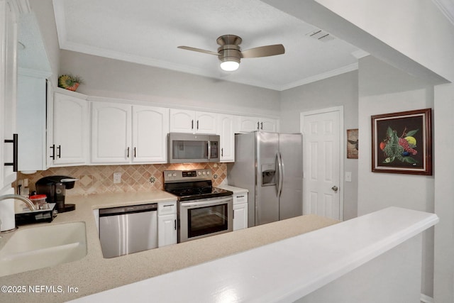 1303 Wood Hill Pl Unit 1303, Jacksonville, FL 32256 - kitchen with stainless steel appliances, a sink, tasteful backsplash, crown molding, and ceiling fan