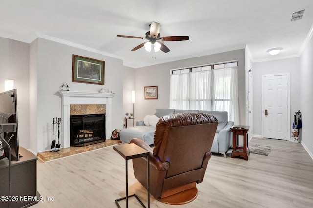 1303 Wood Hill Pl Unit 1303, Jacksonville, FL 32256 - living room with light wood-type flooring, ceiling fan, ornamental molding, a high end fireplace, and baseboards