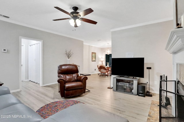 1303 Wood Hill Pl Unit 1303, Jacksonville, FL 32256 - living area with wood finished floors, a ceiling fan, crown molding, and baseboards